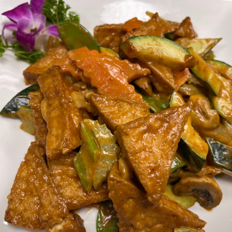 Wild Basil's Thai dish with fried tofu, zucchini, carrots, and mushrooms in a rich sauce.